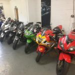 A row of high performance motorcycles in A&S garage